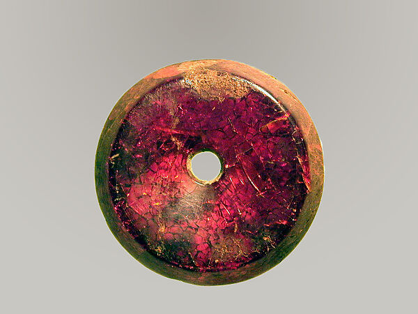 Pierced disk, perhaps from an earring or fibula (safety pin)