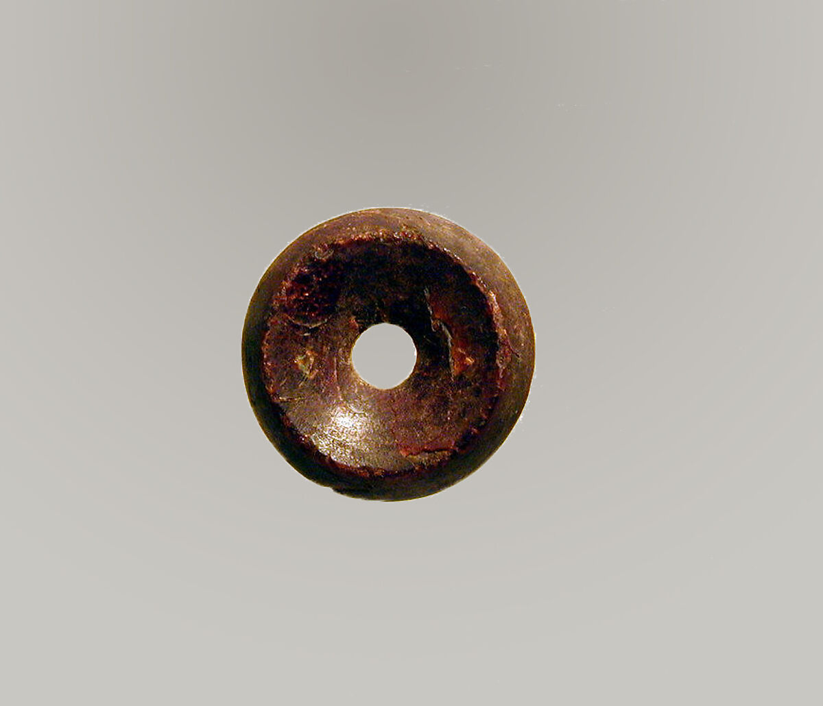 Pierced disk, perhaps from an earring or fibula (safety pin), Amber, Etruscan or Italic 