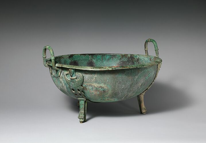 Bronze handled basin with three feet