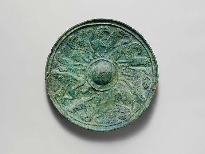 Bronze shield boss with griffin and sphinx frieze