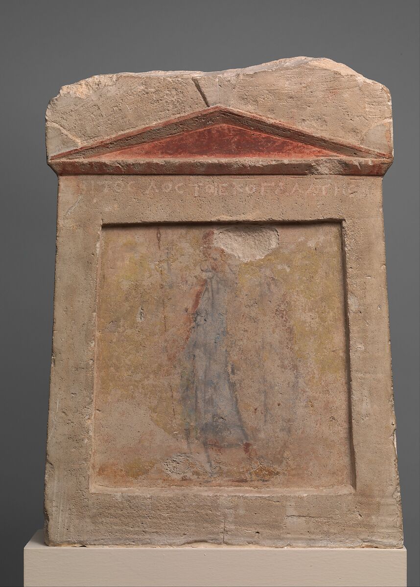 Painted limestone funerary slab with a soldier standing at ease