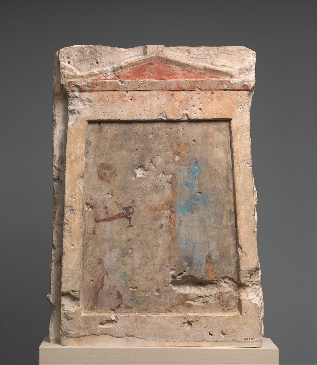 Painted limestone funerary slab with a soldier taking a kantharos from his attendant