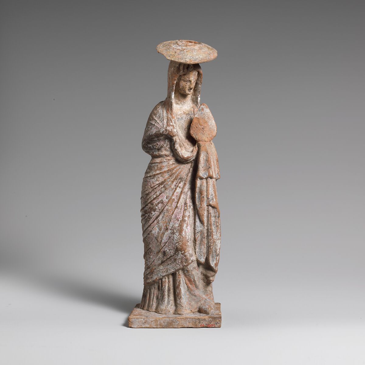 Terracotta statuette of a woman wearing a hat and holding a fan, Terracotta, Greek, Boeotian 