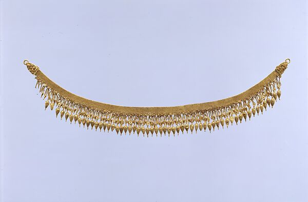 Gold strap necklace with seedlike pendants