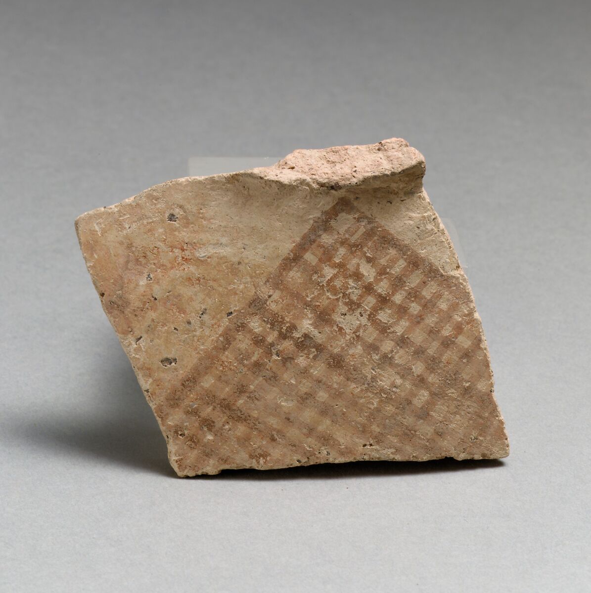 Terracotta upper-body fragment with hatched triangle, probably from a pyxis (box with lid), Terracotta, Minoan 