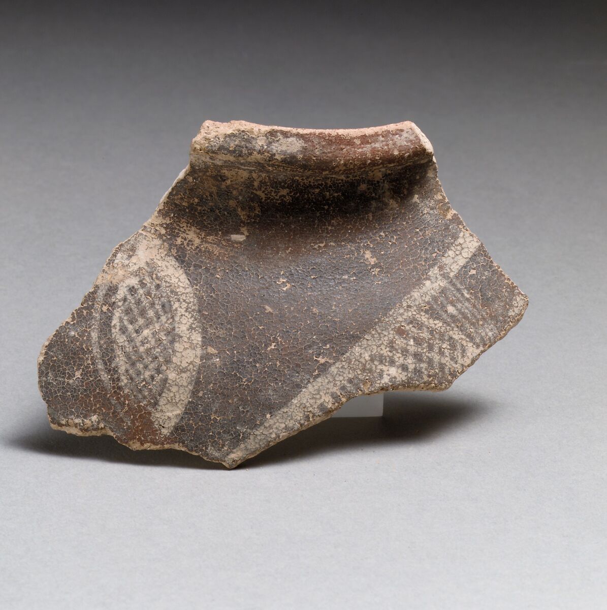 Terracotta rim fragment with cross-hatched lozenges, Terracotta, Minoan 