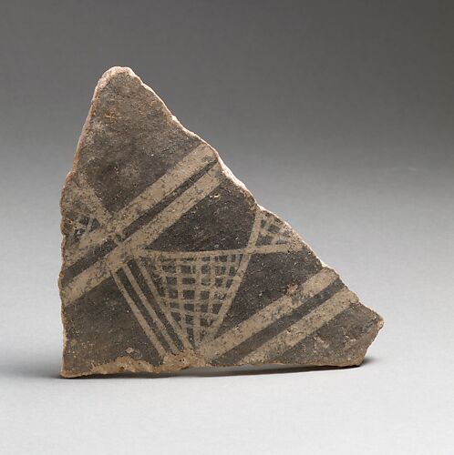 Terracotta vessel fragment with cross-hatched triangles and broad bands