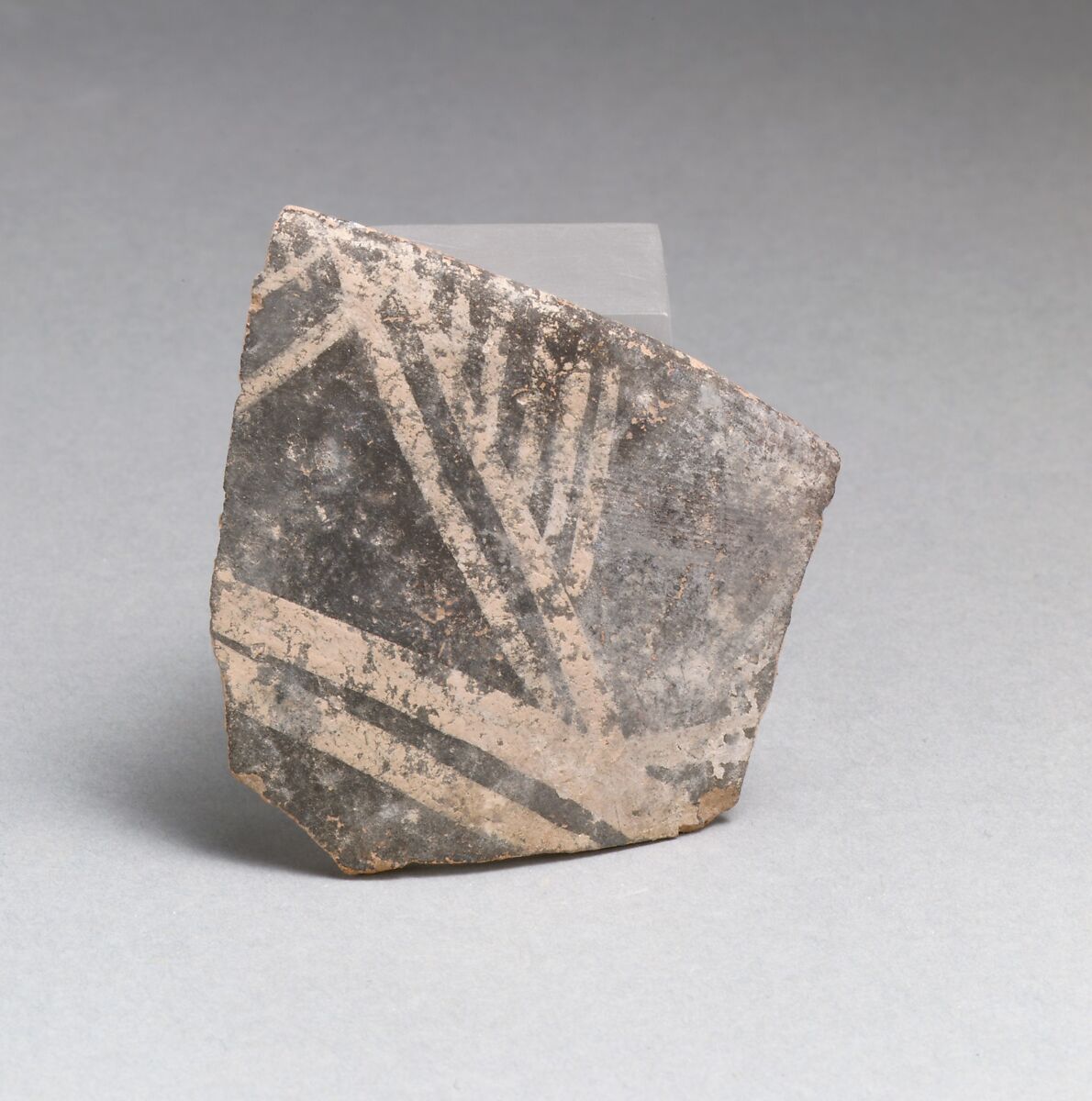 Terracotta rim from a cup with triangles and parallel vertical lines, Terracotta, Minoan 