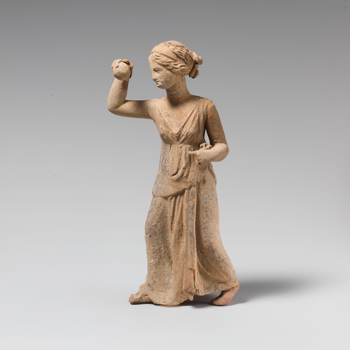 Terracotta statuette of a girl playing ball, Terracotta, Greek, South Italian 