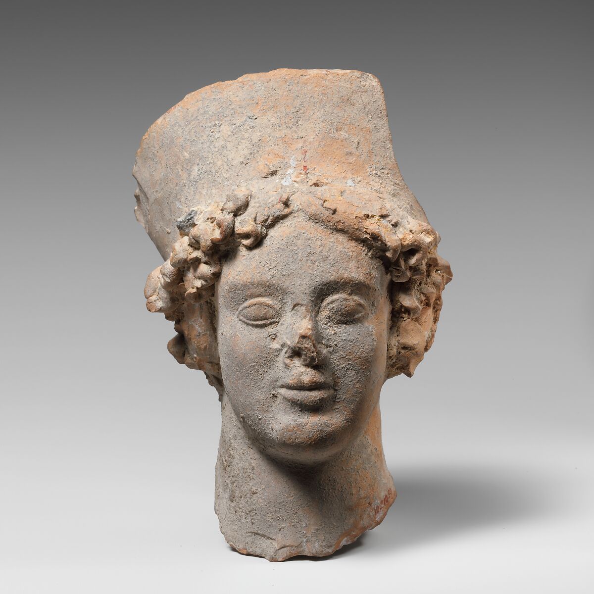 Terracotta head of a woman wearing a high headdress, Terracotta, Greek, South Italian, Tarentine 