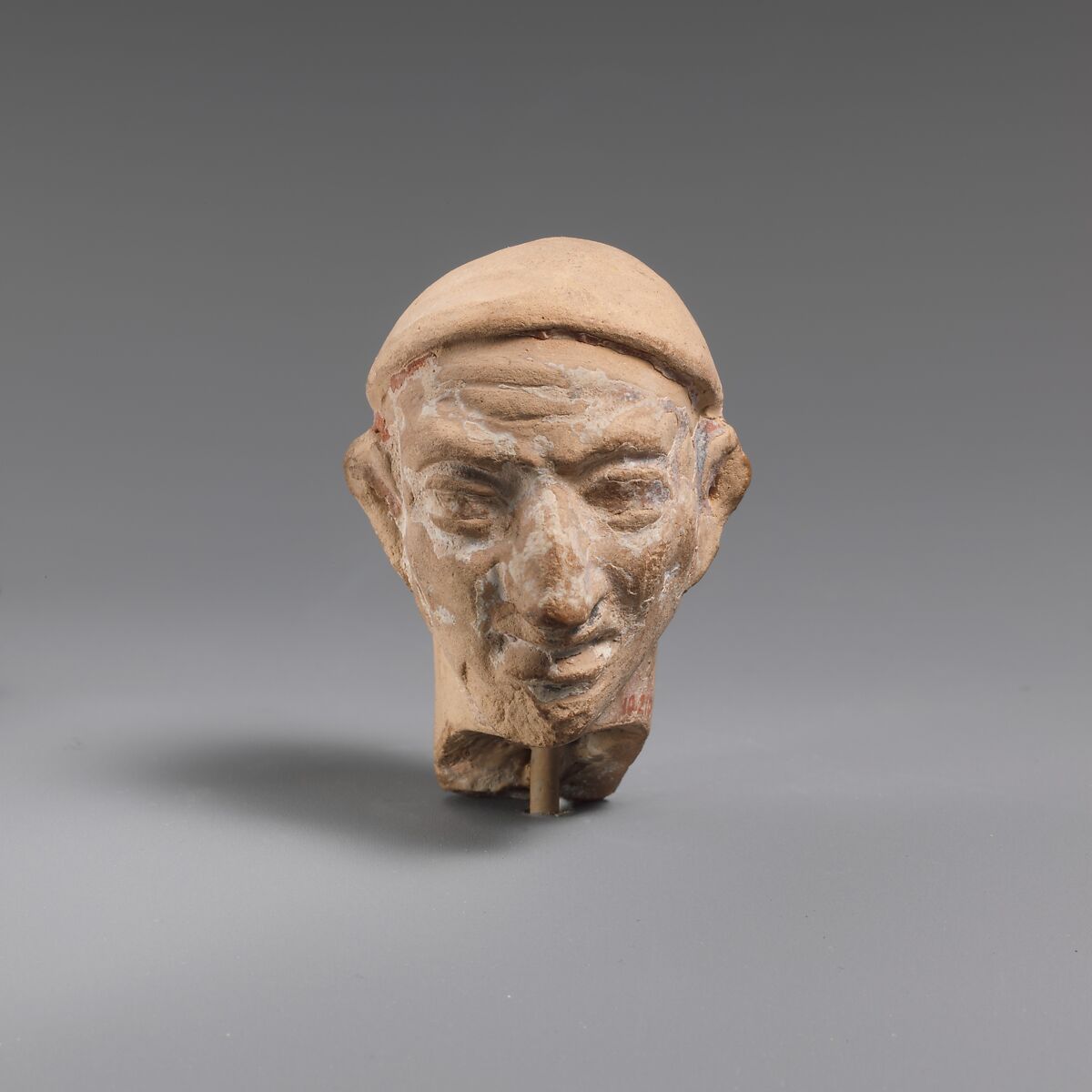 Terracotta head of a man wearing a cap, Terracotta, Greek 