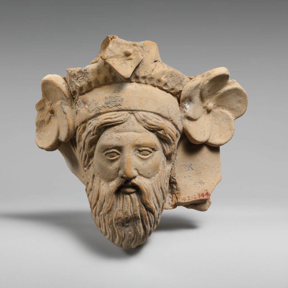 Terracotta head of a man, possibly Dionysos, Terracotta, Greek, South Italian, Tarentine 