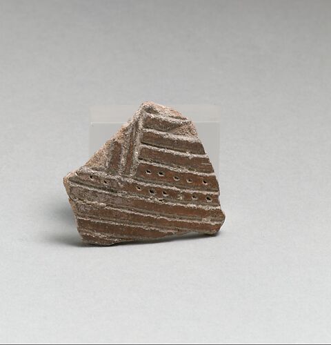 Terracotta vessel fragment with incised lines and punctations