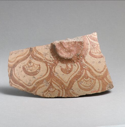 Terracotta vessel fragment with reticulated pattern enclosing conventional flowers