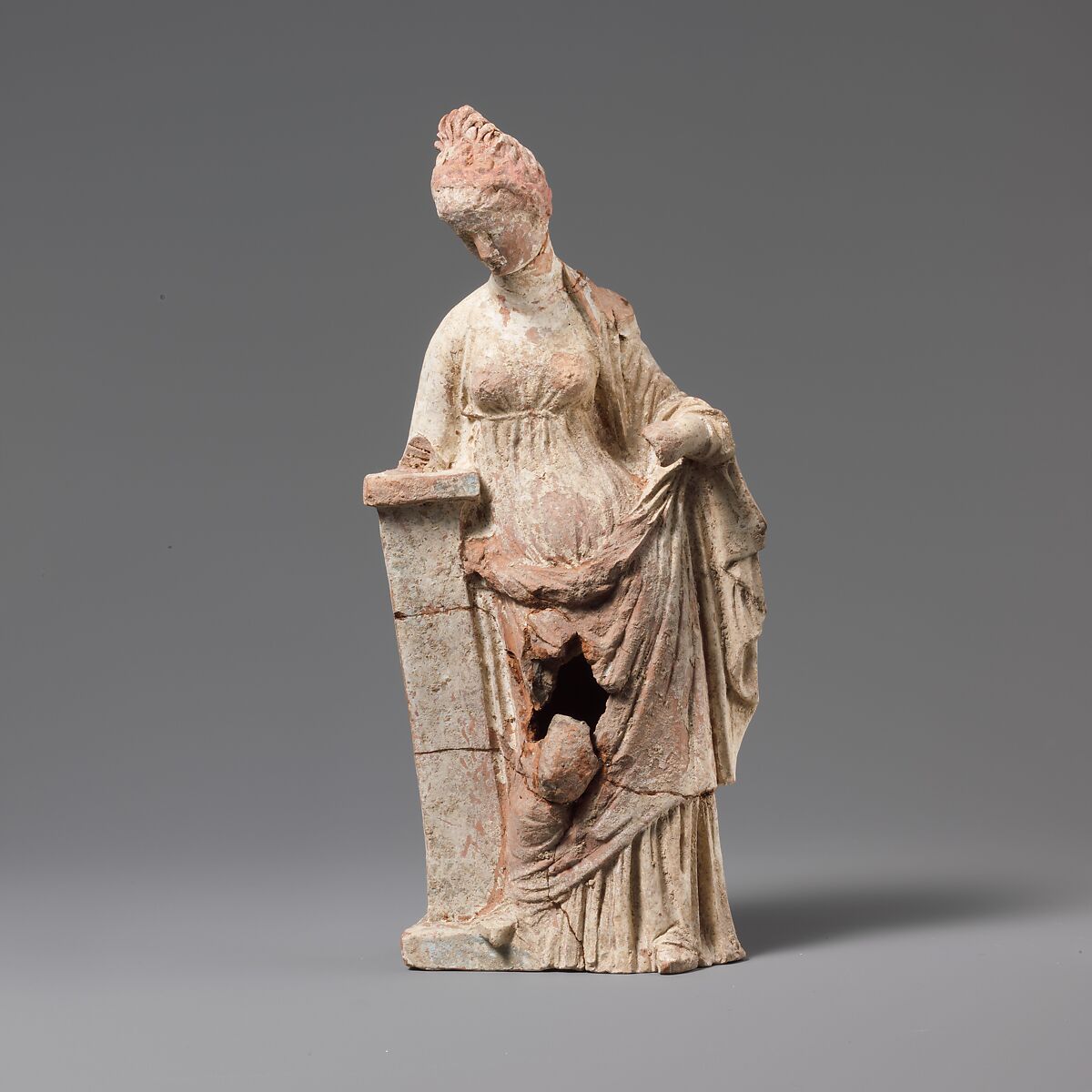 Terracotta statuette of a woman leaning on a pillar, Terracotta, Greek, South Italian, Tarentine 