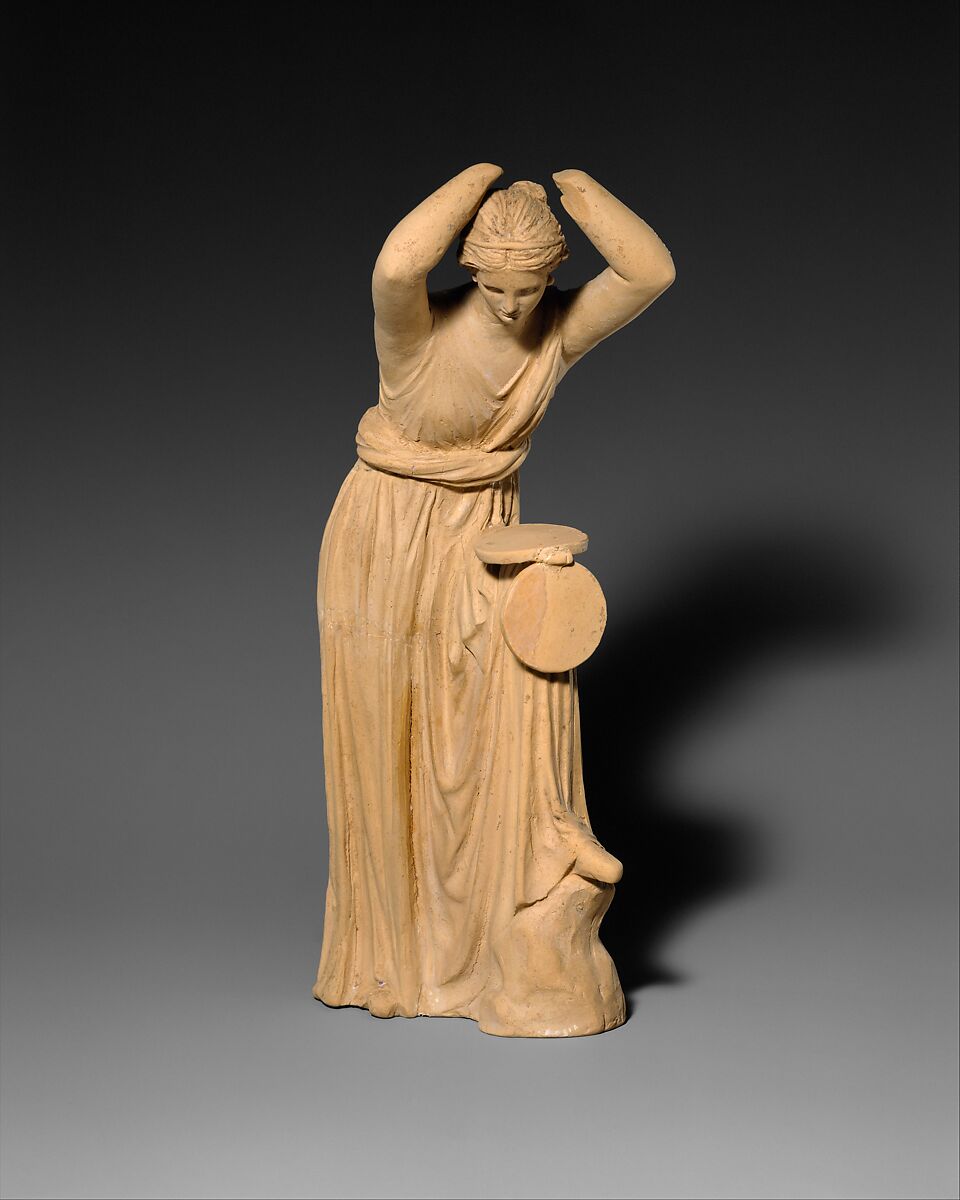 Terracotta statuette of a woman looking into a box mirror, Terracotta, Greek, probably West Greek, possibly Centuripe 