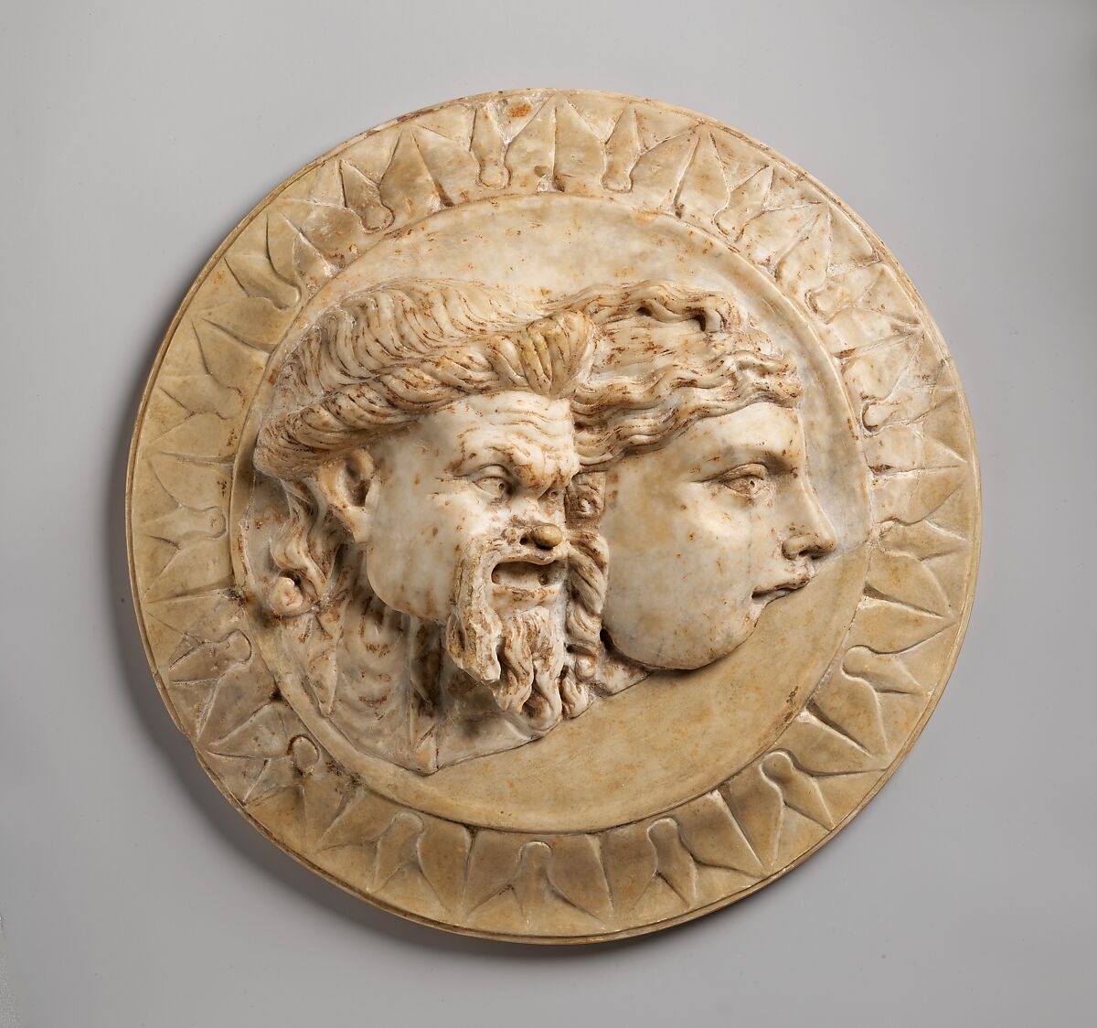 Marble disk with two theater masks in relief, Marble, Roman 