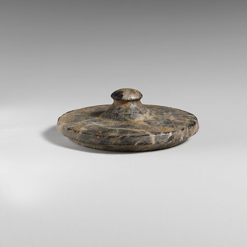 Stone lid of a pyxis