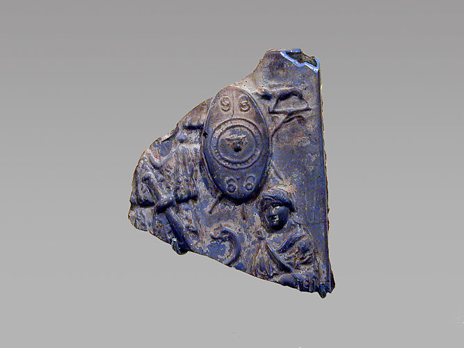Glass plaque fragment depicting a trophy and captives