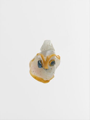 Glass pendant in the form of a demonic mask