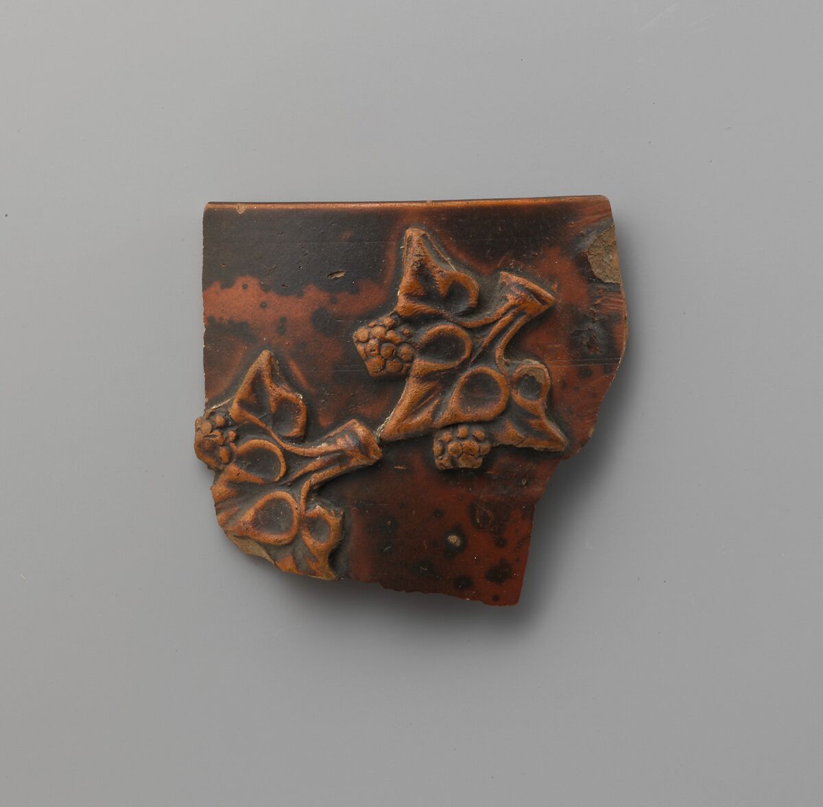 Terracotta applique fragment of ivy leaves and berries, Terracotta, Greek, Pergamene 