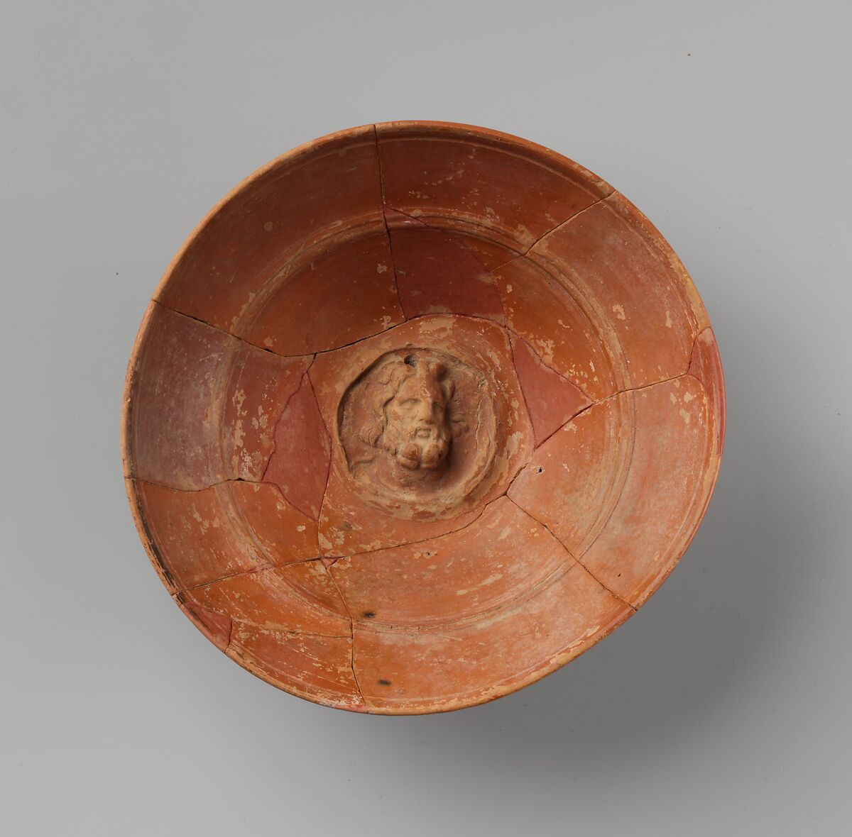 Terracotta emblem bowl with head of Zeus or Sarapis, Terracotta, Greek 