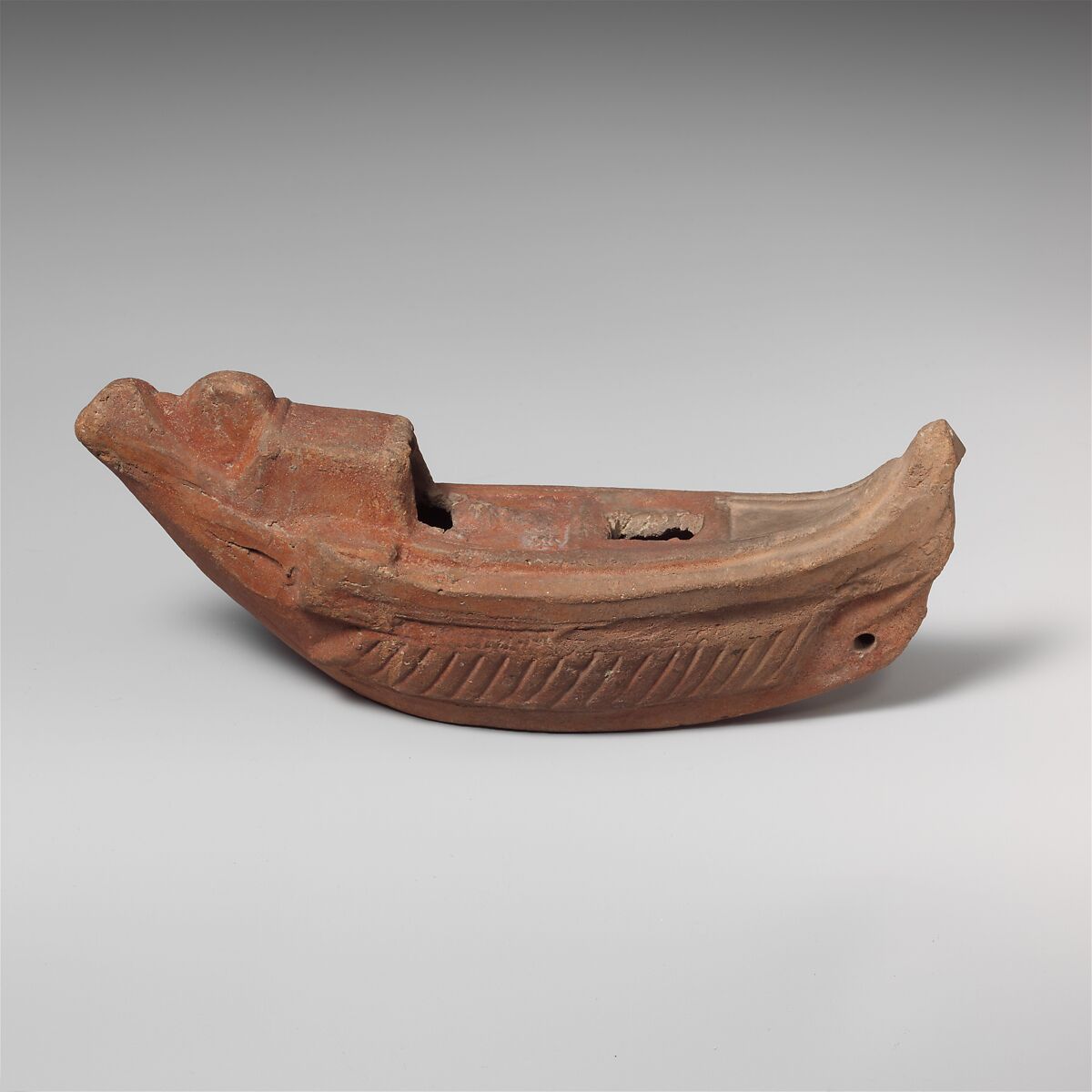 Terracotta oil lamp in the shape of a boat, Terracotta, Roman, Egyptian 