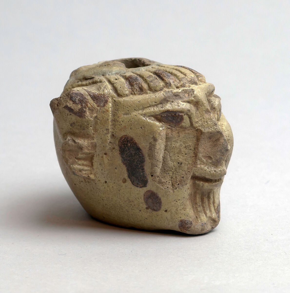 Faience aryballos (perfume vase) in the form of a head of Acheloös, Faience, East Greek