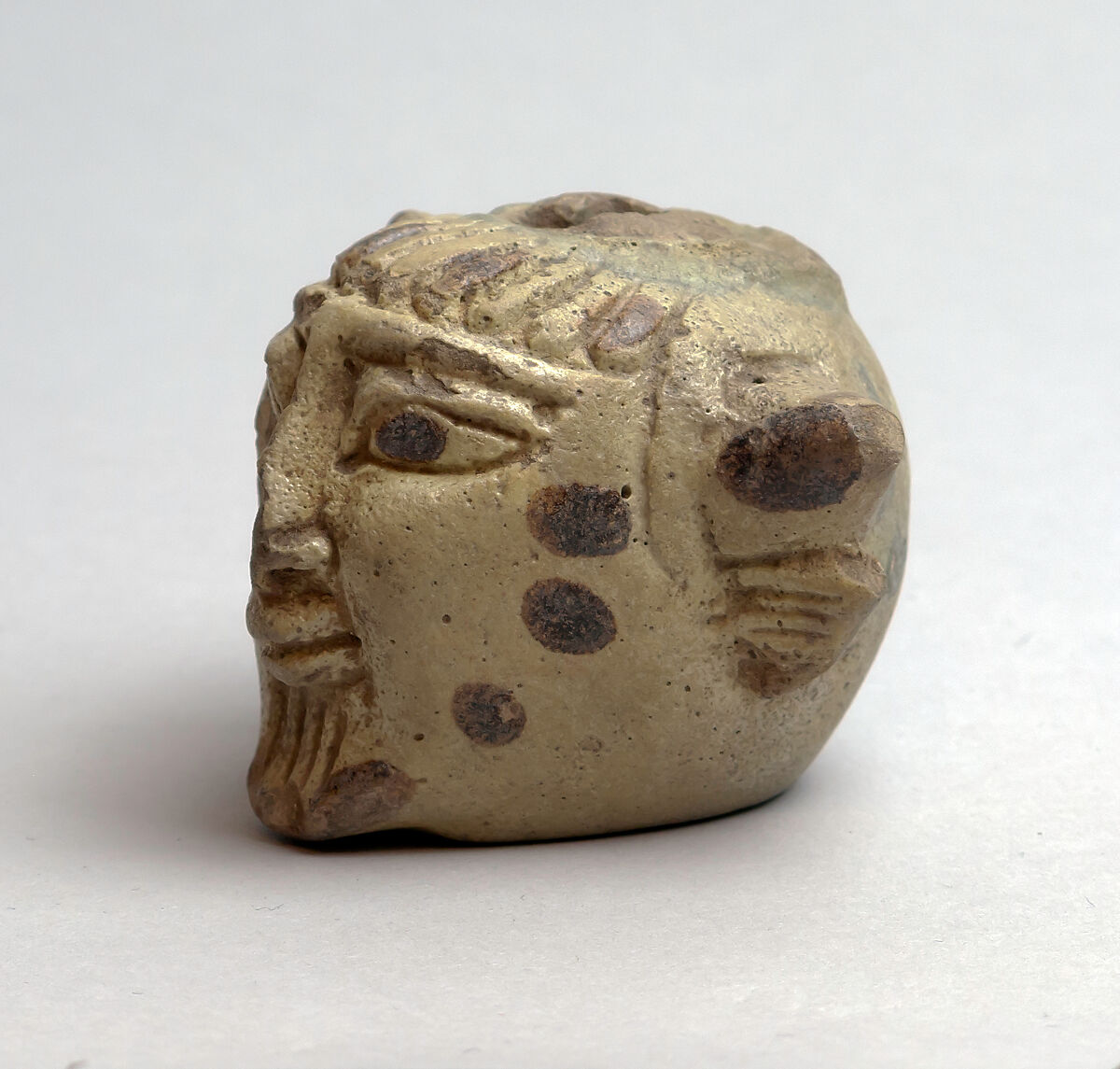 Faience aryballos (perfume vase) in the form of a head of Acheloös, Faience, East Greek