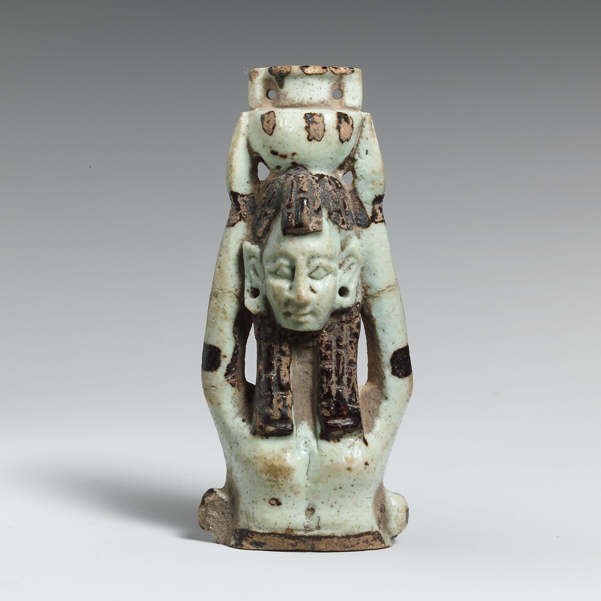Fragment of a faience statuette of a woman holding a vase on her head, Faience, East Greek 