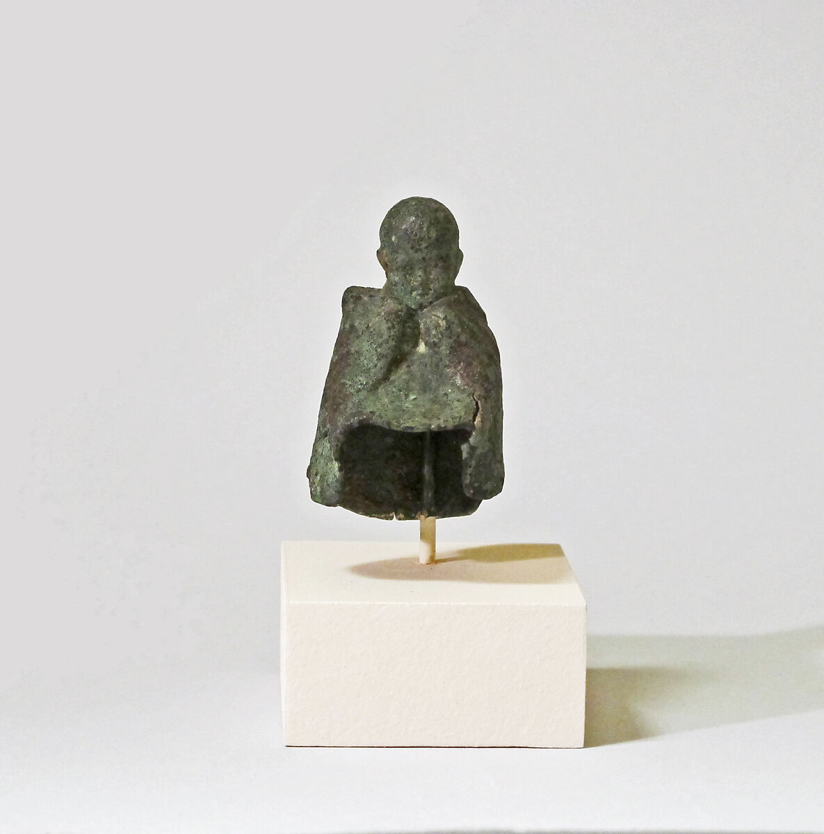 Fragmentary bronze statuette of boy wearing a mantle, Bronze, Roman 