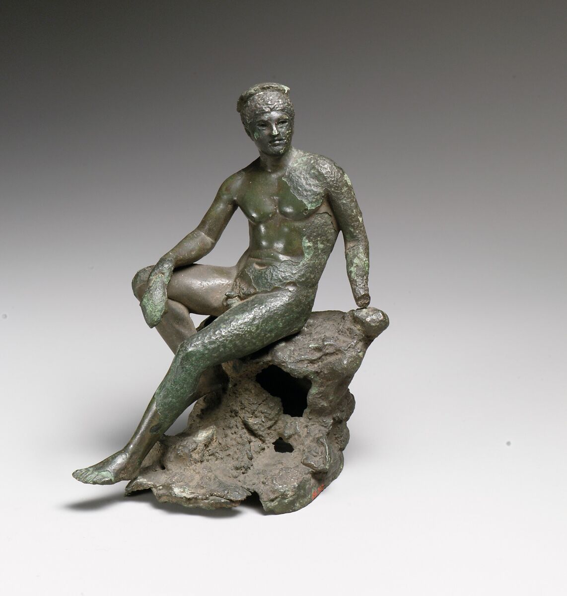 Bronze statuette of Hermes seated on a rock, Bronze, Roman 