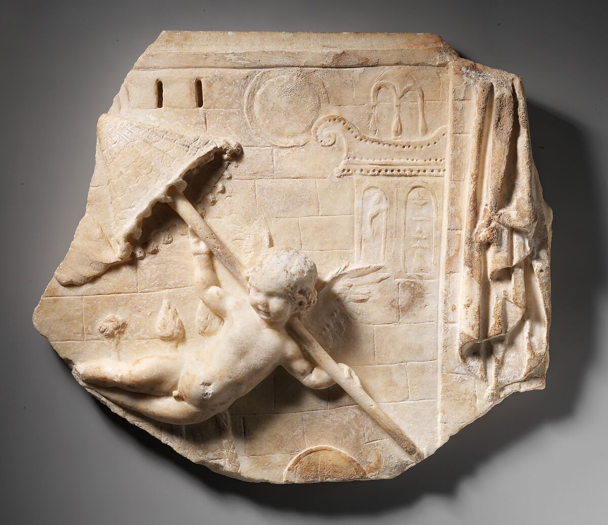 Marble fragment of a relief with a flying Eros, Marble, Roman 