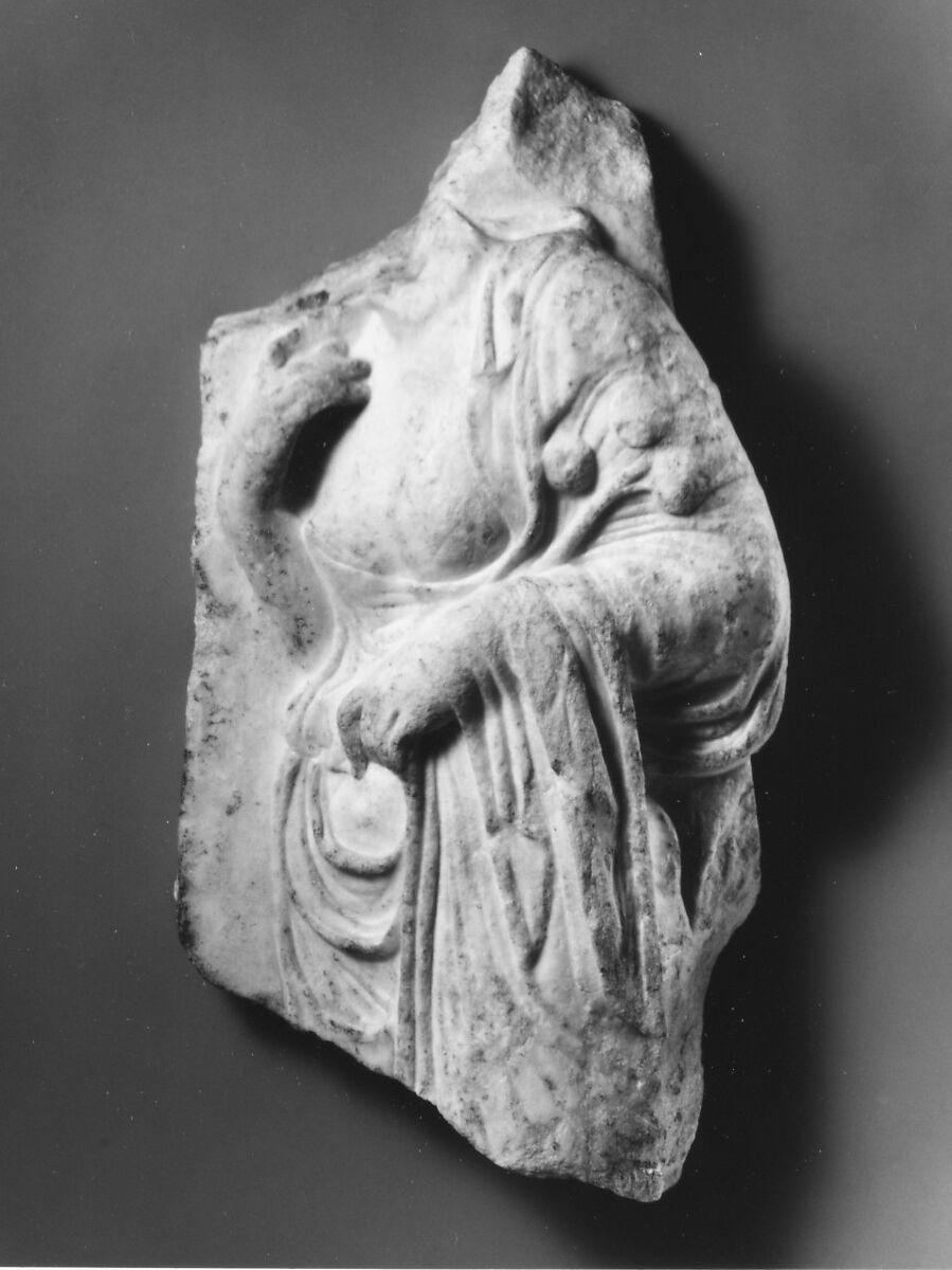 Marble relief fragment with the torso of a Hesperid holding apples, Marble, Pentelic, Roman 