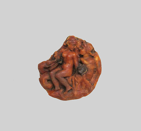 Amber disk with a nereid riding a triton