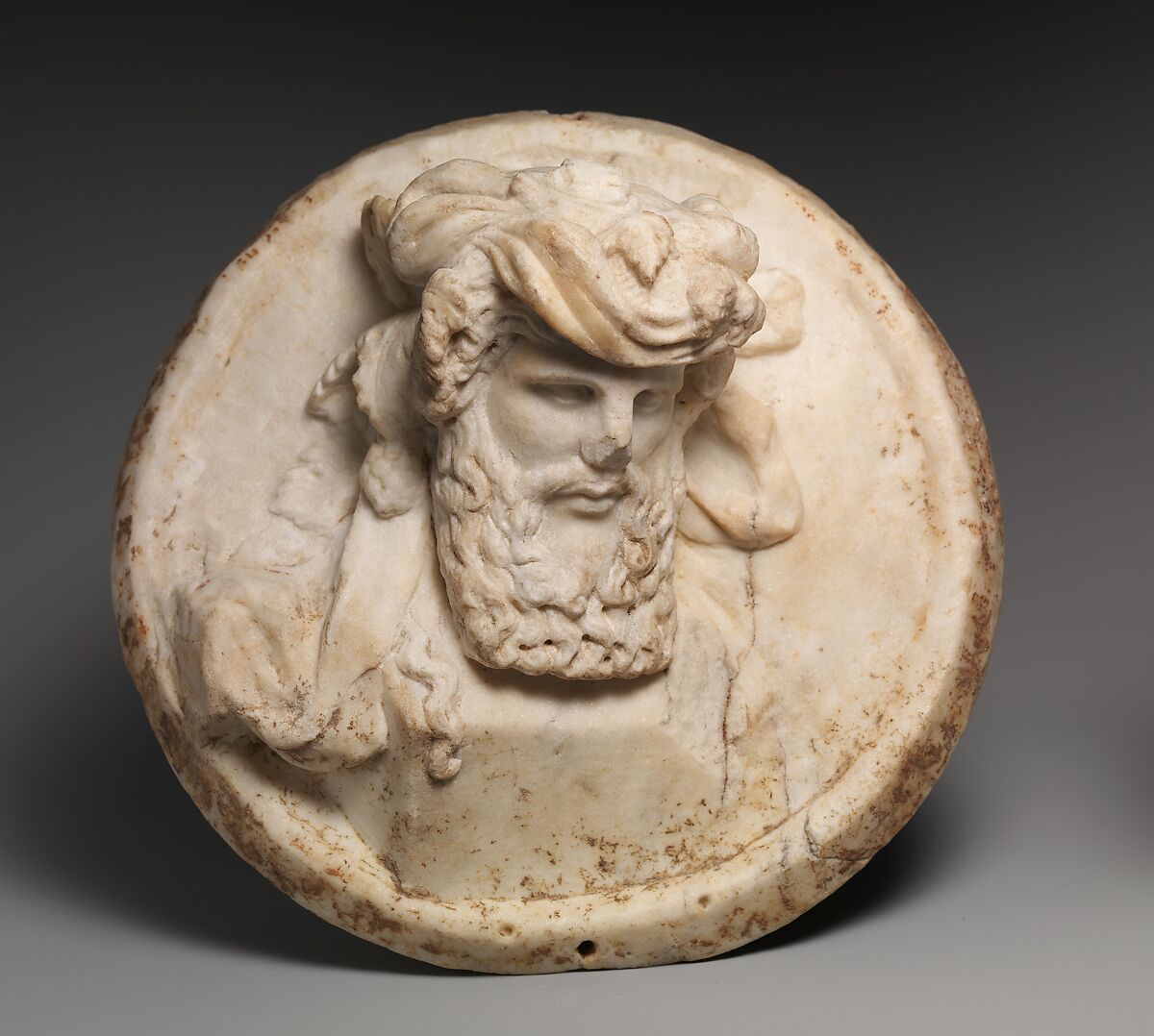 Marble disk with a herm of Dionysus in relief, Marble, Roman 