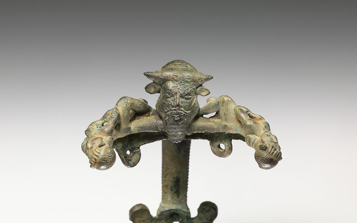 Bronze oinochoe (jug) handle with satyrs flanking a head of Acheloos, Bronze, Etruscan