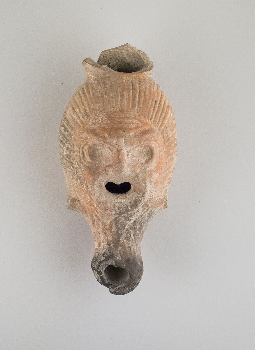 Terracotta lamp in the form of a grotesque head, Terracotta, East Greek, Lydian 