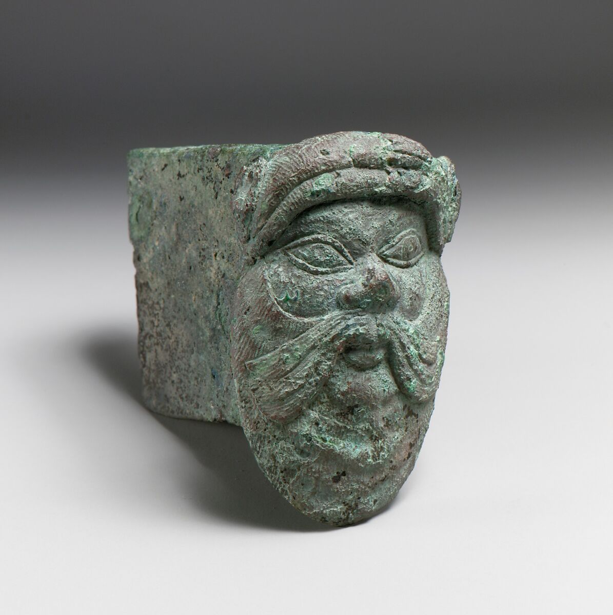 Fragment of a cart or chariot, socket with satyr mask, Bronze, Etruscan 