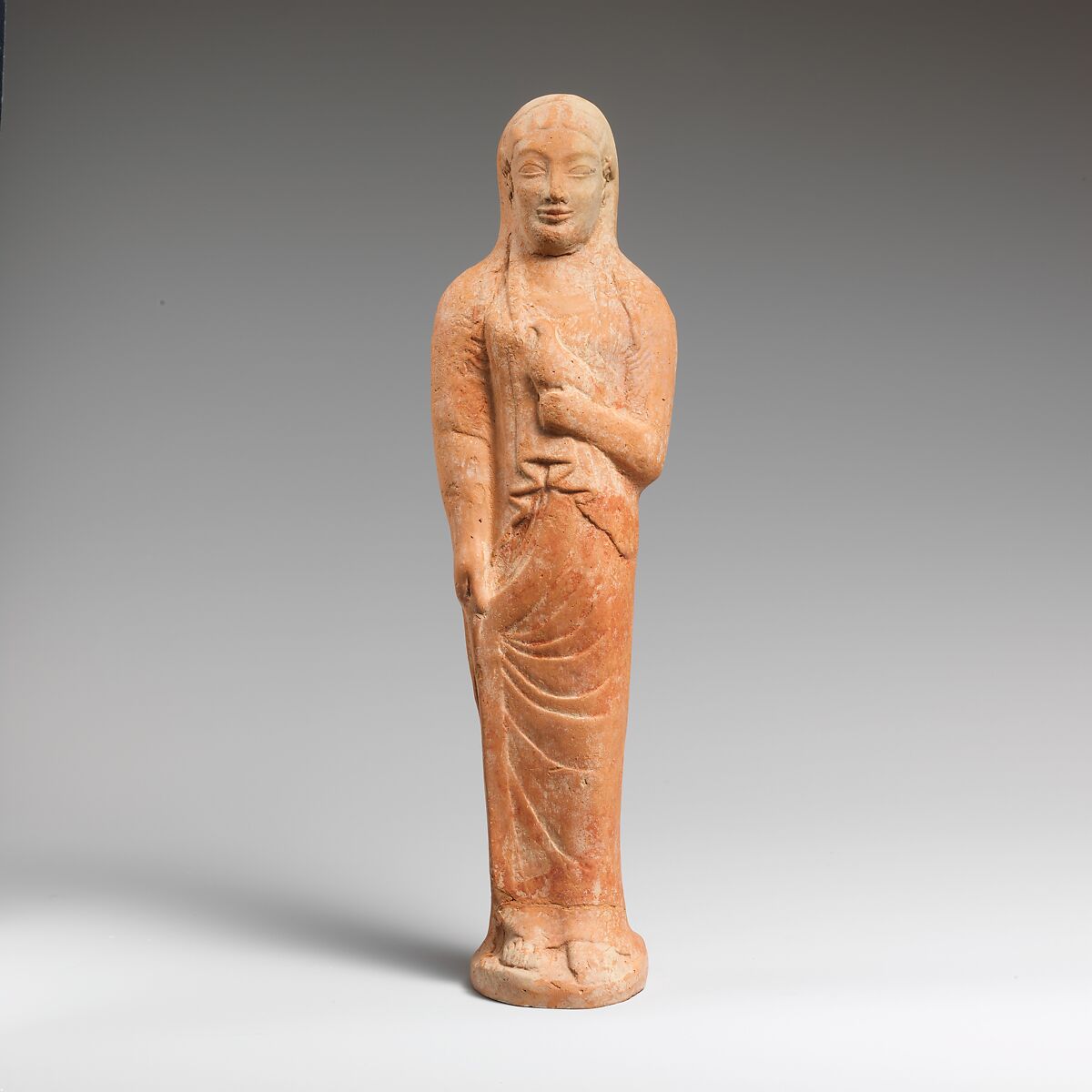 Terracotta statuette of a woman holding a bird, Terracotta, East Greek 