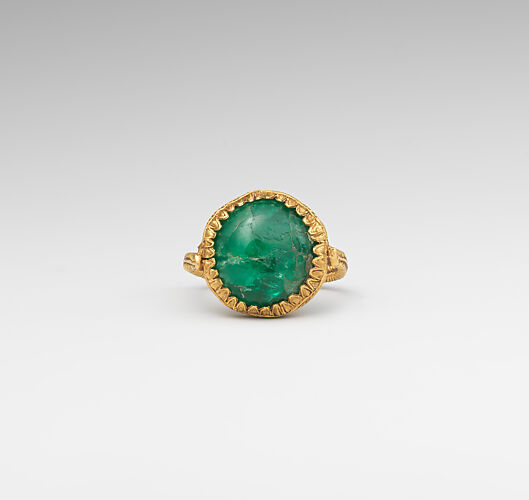 Gold ring set with an emerald