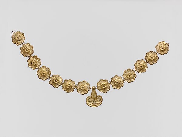 Gilt terracotta ornaments from a necklace