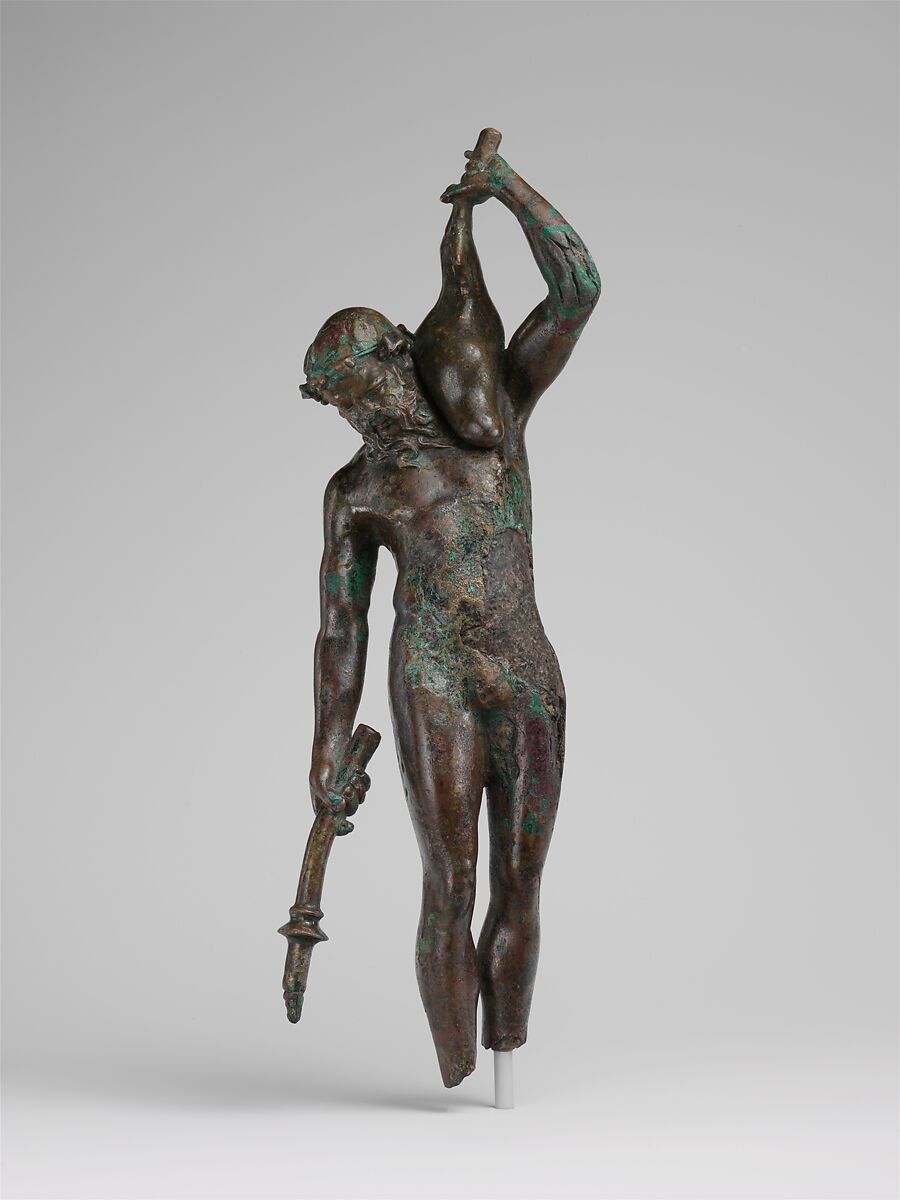 Bronze statuette of a satyr with a torch and wineskin, Bronze, Greek 