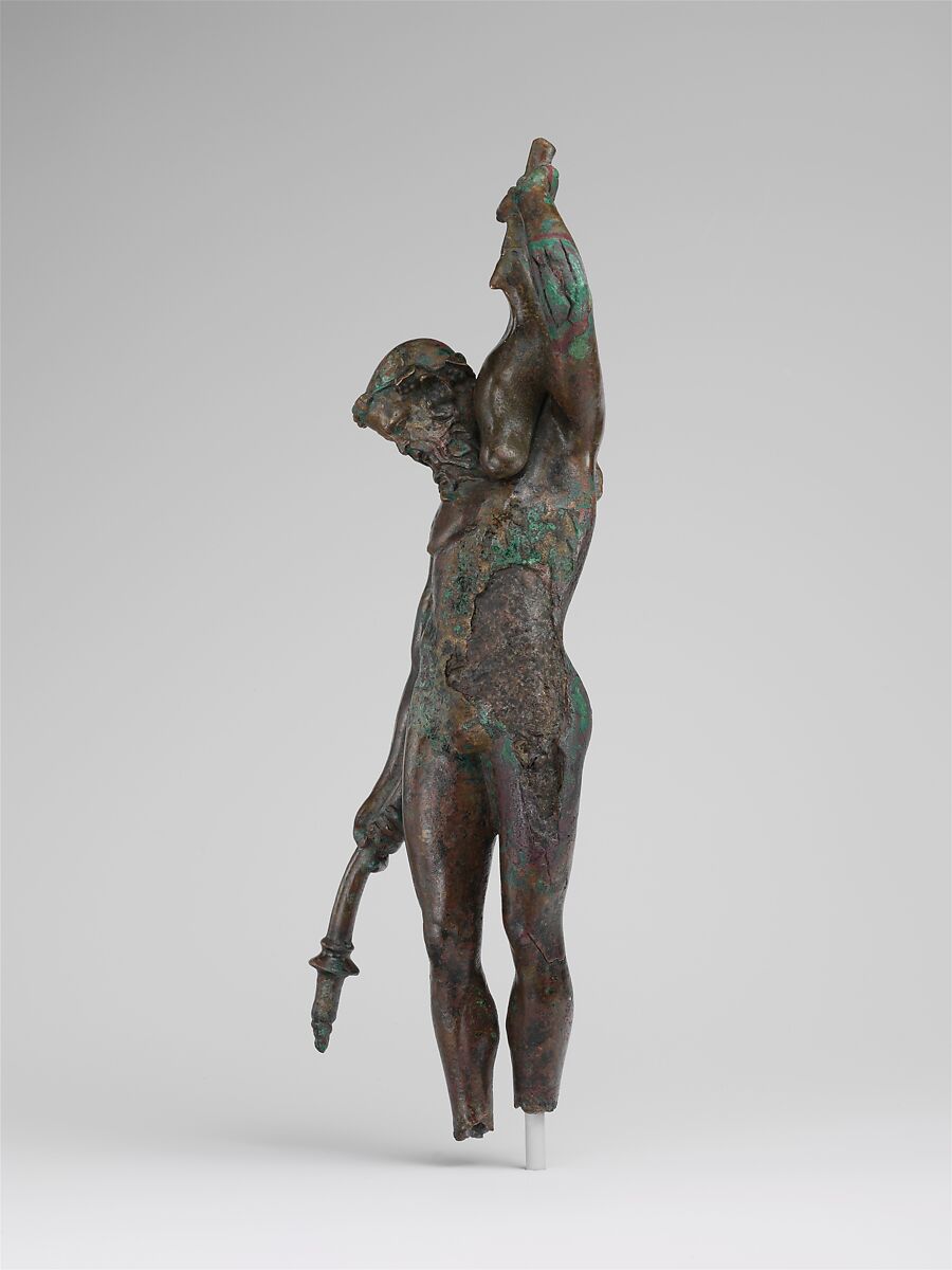 Bronze statuette of a satyr with a torch and wineskin, Bronze, Greek