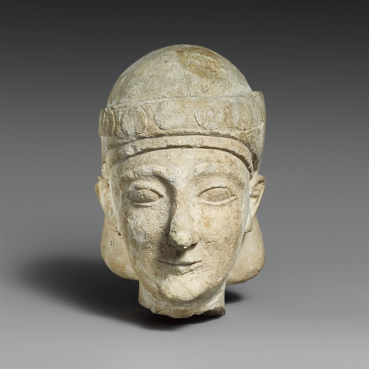 Limestone head of a beardless male with a diadem, Limestone, Cypriot 