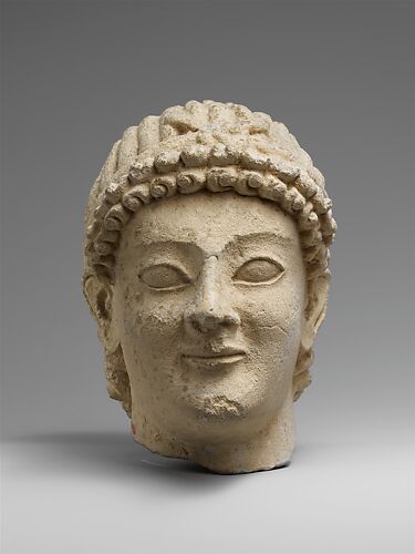 Limestone head of a wreathed youth