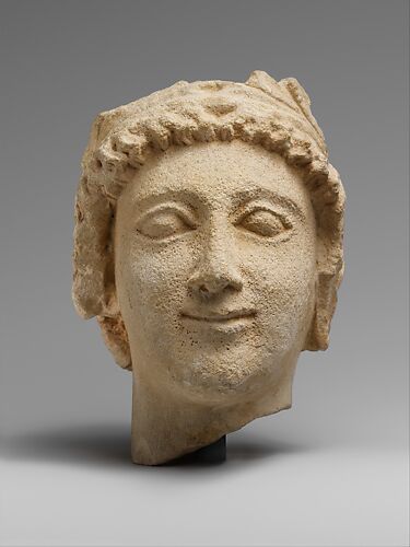 Limestone head of a wreathed youth