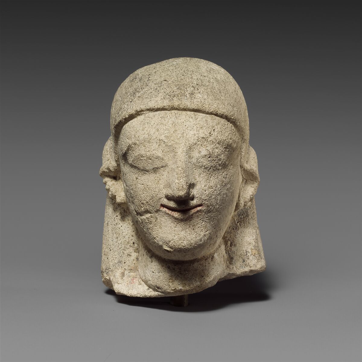 Limestone head of a female with a plain headdress, Limestone, Cypriot 