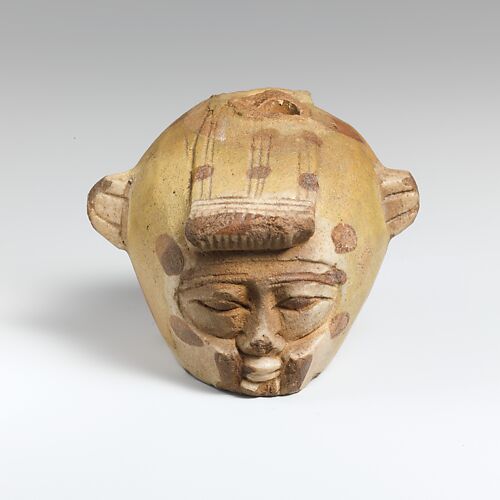 Faience aryballos (oil flask) in the form of a head wearing an animal skin