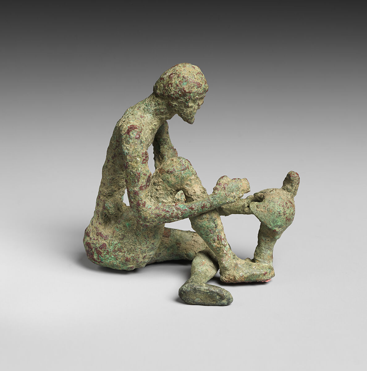 Bronze armorer working on a helmet, Bronze, Greek